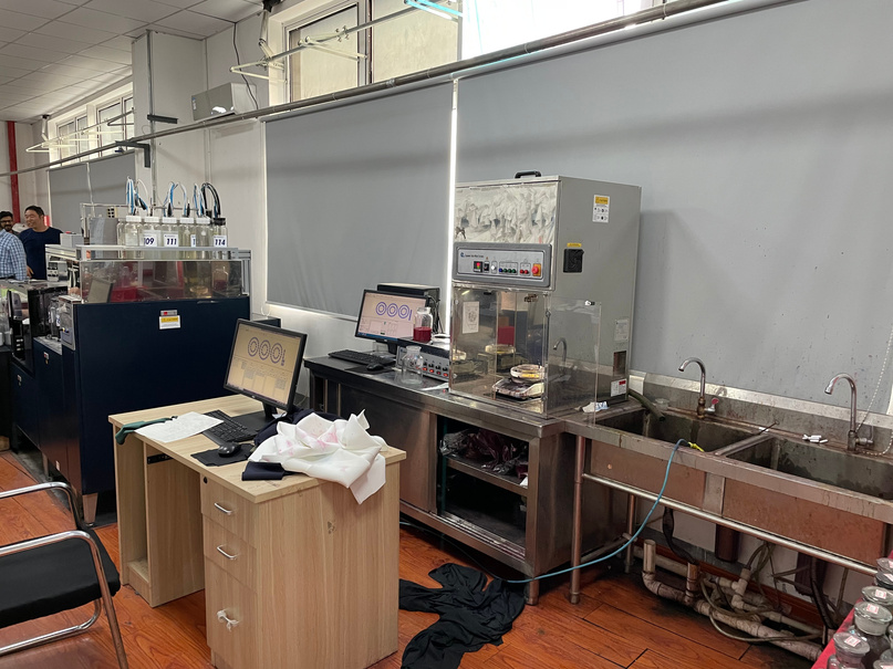 Quality control bench with fabric samples laid out for inspection.