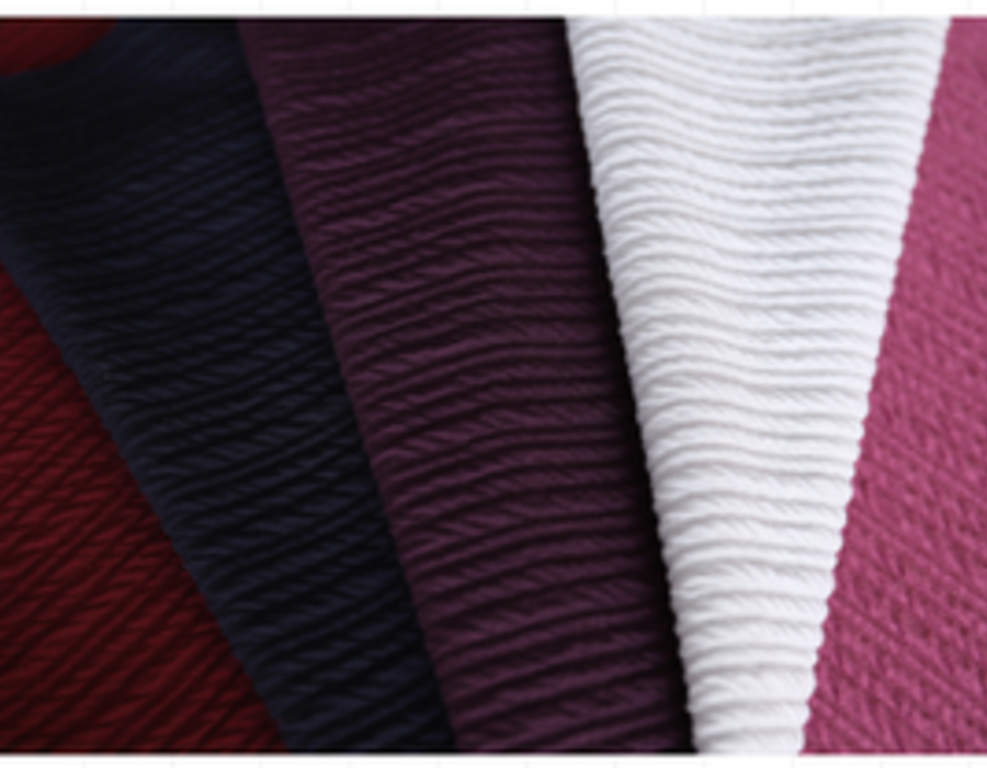 Fan of crinkle seersucker swatches in burgundy, white and pink.
